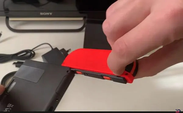 Remove the Nintendo Switch controllers from both ends